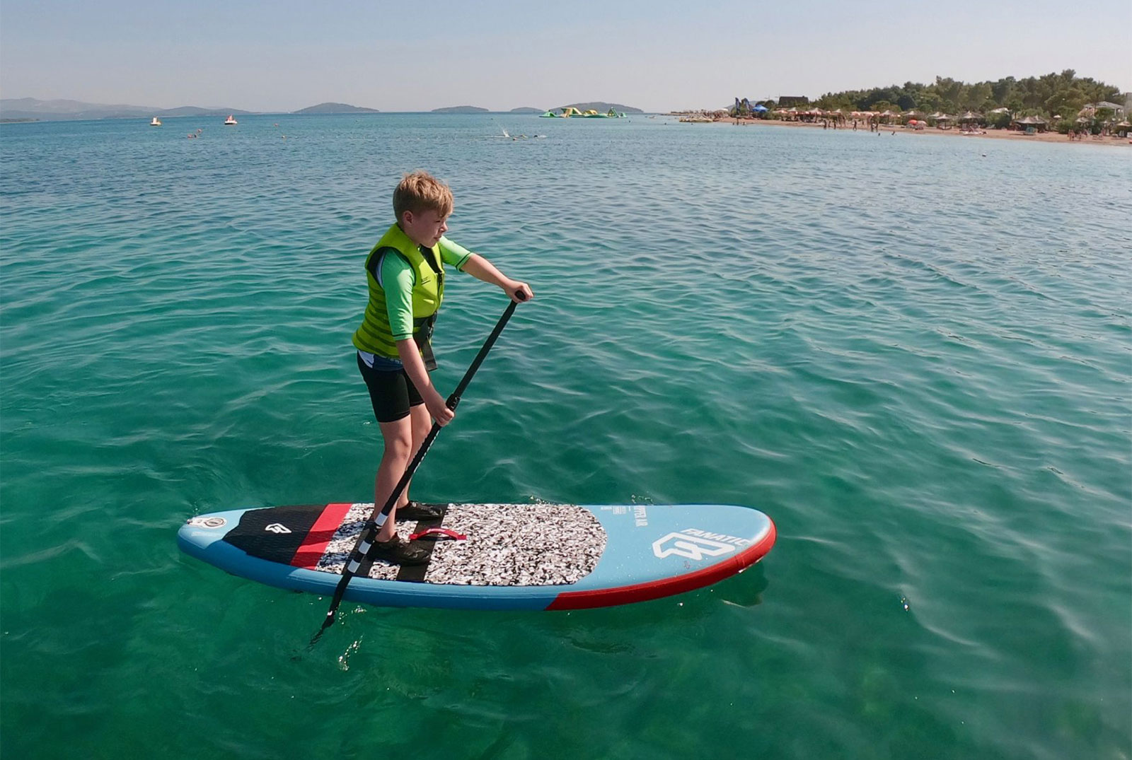 Kid-on-the-SUP-in-the-bay-scaled